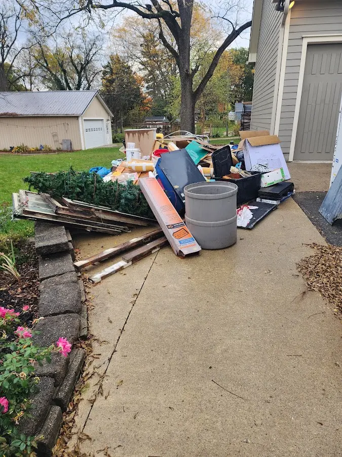 Dumpster being loaded with debris for Estate Cleanout Dumpster Rental in Amherst